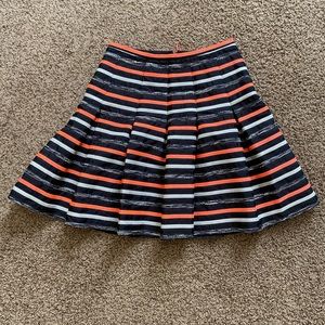 Anthropology HD in Paris circle skirt with bright orange and black strips.
